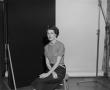 Photograph: [Doris sitting on a stool, in a studio, 2]