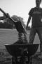 Photograph: [Student dumping gravel in wheelbarrow]