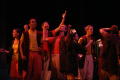 Photograph: [UNT Antigone ensemble interacting on stage]