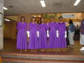 Photograph: [Performers in purple dresses]