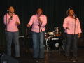 Photograph: [Three singers on stage at Multicultural Center event]