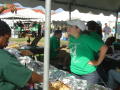 Photograph: [Andrea Robledo serving food at tailgate]