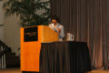 Photograph: [Woman introducing panel during 2012 TABPHE conference]