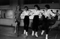 Primary view of [Alice Faye dancing with three women]