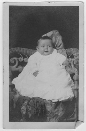 Primary view of object titled '[A baby in a wicker chair]'.