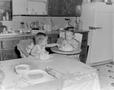 Photograph: [Pam and Byrd eating cake in high chairs, 2]