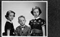 Photograph: [Three children with serious expressions on their faces]