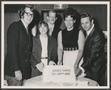Photograph: [People smiling at camera and holding cake]