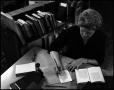 Photograph: [Woman working on book bindery process]