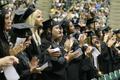 Photograph: [Students clap during UNT's 2008 graduation ceremony]