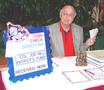 Photograph: [TXSSAR member sits at donations table during 109th Annual State Conv…
