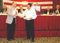 Photograph: [Man receives certificates at the TXSSAR 109th Annual State Conventio…