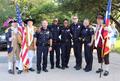 Photograph: [TXSSAR Color Guard members with police officers during July 2018 par…