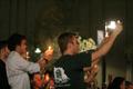 Photograph: [People hold candles at outdoor vigil, 2]