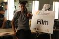 Photograph: [Student stands next to "Film" sign at 2016 TBAAL Summer Youth Arts I…