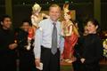 Photograph: [Earl Gibbons poses with Thai puppets, 2]