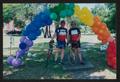 Photograph: [Two cyclists posed under a rainbow arch: Lone Star Ride 2002 event p…