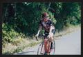 Photograph: [Cyclist riding on the edge of a road: Lone Star Ride 2002 event phot…