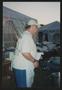 Photograph: [Volunteer in a white apron helping cook: Lone Star Ride 2003 event p…