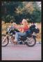 Photograph: [Woman ridding by on her motorcycle with camping gear: Lone Star Ride…