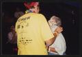 Primary view of [Janie Bush getting pied by a man in a yellow crew t-shirt: Lone Star Ride 2001 event photo]