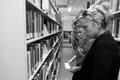 Photograph: [Library employee helps student find book, 1]