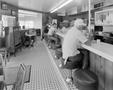 Photograph: [Individuals eating in a diner]