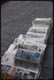 Thumbnail image of item number 1 in: '[Stacks of newspapers on the ground]'.