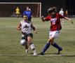 Photograph: [Nikki Crocco races SMU opponent for the ball]
