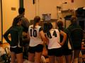 Photograph: [Erica Wendell, Katie Ruiz and others huddle on the sidelines]