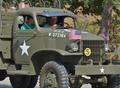 Primary view of [Men drive military vehicle at 2011 Homecoming Parade]