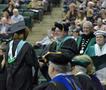 Primary view of [Jerry Thomas presents Master of Education degree to graduate]