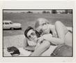Photograph: [Teenage couple lounging outdoors]