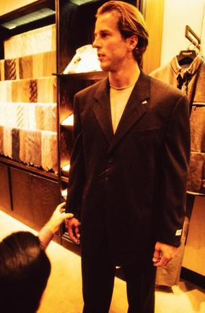 Primary view of object titled '[Mike Modano being fitted for a suit]'.