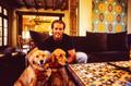 Primary view of [Mike Modano posing with his two golden retrievers]