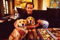 Photograph: [Mike Modano hugging his two golden retrievers for a portrait]
