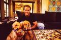 Photograph: [Mike Modano trying to pose with his two dogs]