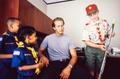Photograph: [Mike Modano posing with three young boy scouts]