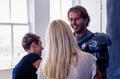 Primary view of [Mike Modano smiling at a blonde women during a photo shoot]