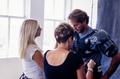 Primary view of [Mike Modano having his hair and clothes being adjusted by two women during a photo shoot]