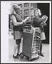Photograph: [Photograph of two women handing out Meacham's Fashion News on the st…