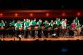 Photograph: [Rows of percussionists in green shirts performing onstage, 2]