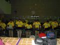 Photograph: [Rows of drummers in yellow shirts performing, 1]