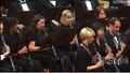 Photograph: [Rows of people dressed in black playing clarinets]