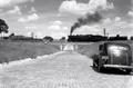 Photograph: [Stepping Back in Time: Vintage Car and Steam Engine Encounter]