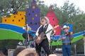 Photograph: [Cowboys performing on colorful stage]