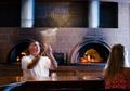 Photograph: [Chef tossing pizza dough]