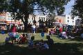 Primary view of [People sitting on the lawn of the old Denton County Courthouse, on County Seat Saturday]