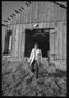 Photograph: [Girl Holding a Guitar Outside of a Barn]