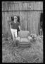 Photograph: [Boy Next to an Old Chair]